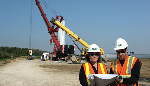 BMEI construction project team discussing a wind farm project in the field